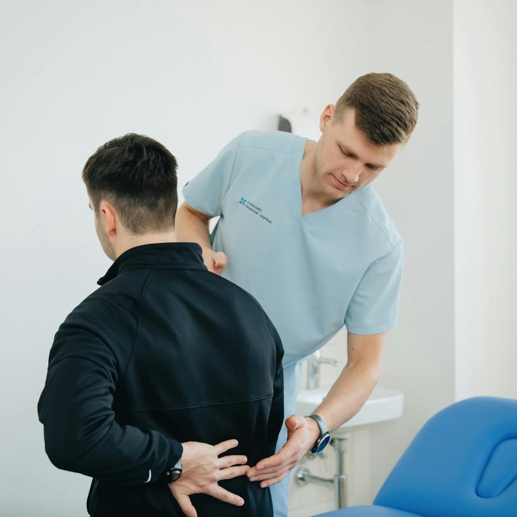 physiotherapist looking at patient back